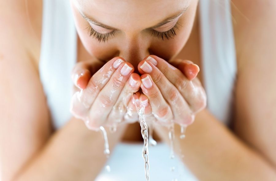 Woman Washing Her Face with Water